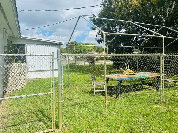 a view of a chair and table in the backyard