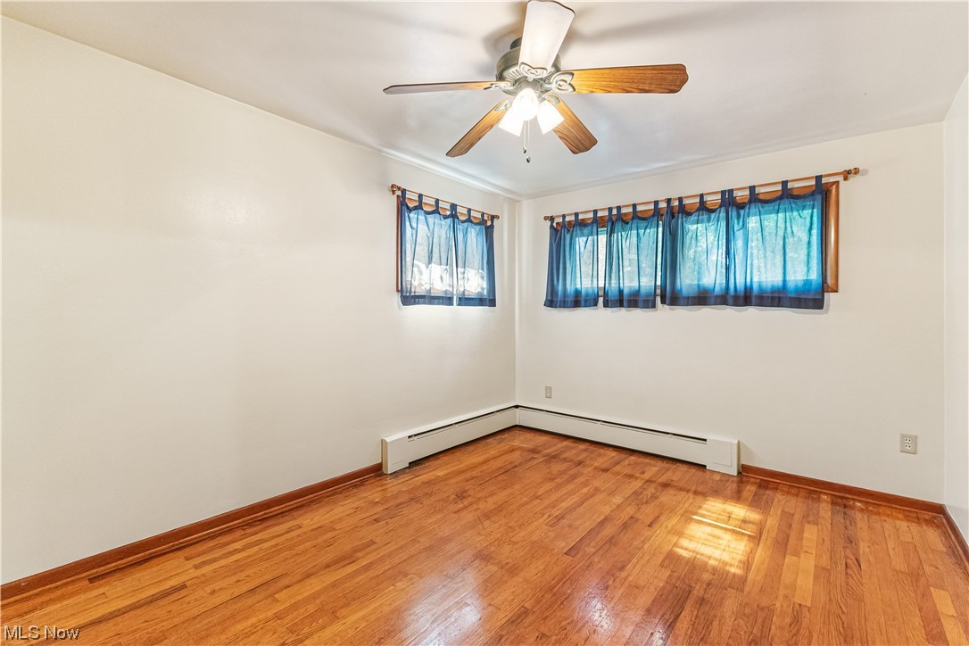 319 Glenview Road Canfield, OH 44406 - Photo 14 of 31 Unfurnished room featuring ceiling fan, a wealth of natural light, and light hardwood floors