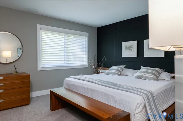 a bedroom with a bed and a dresser