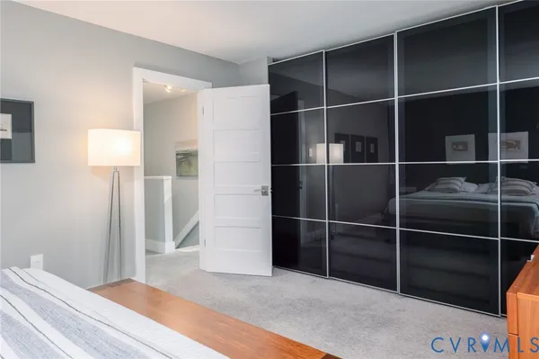 a view of empty room with wooden floor and windows