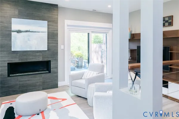 a living room with furniture and a fireplace