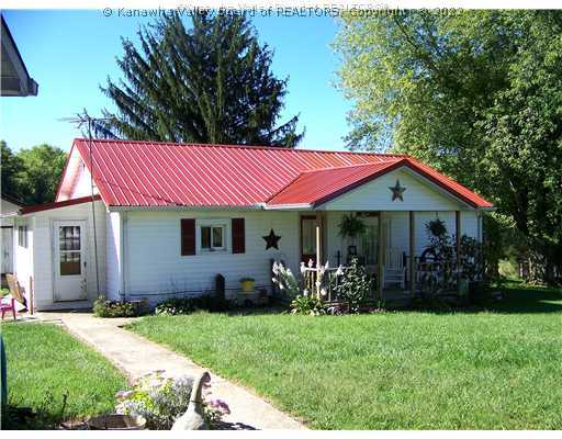 Exterior Front. Simple country home with new metal roof on 3.5 acres.