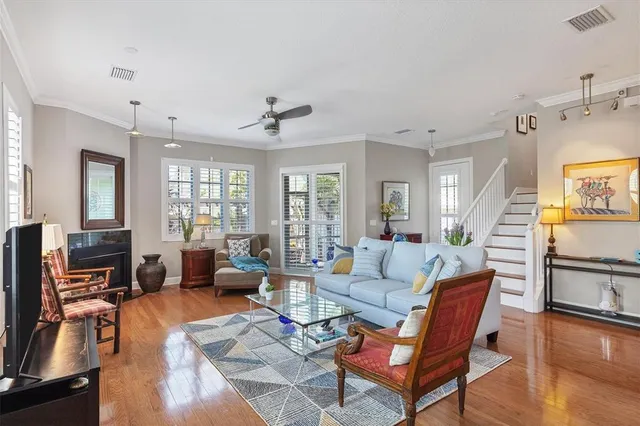 a living room with furniture large window and fireplace