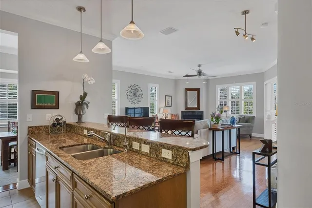 a bedroom with a bed wooden floor and ceiling fan