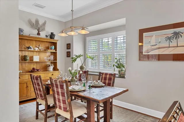 a view of a balcony with two plants and wooden fence
