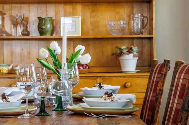 a bathroom with a tub a potted plant and a large window