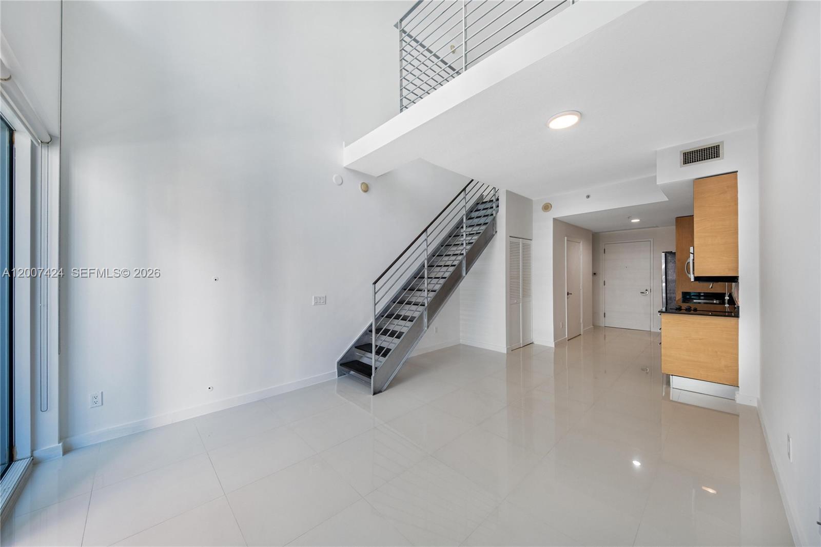 a view of an empty room with stairs