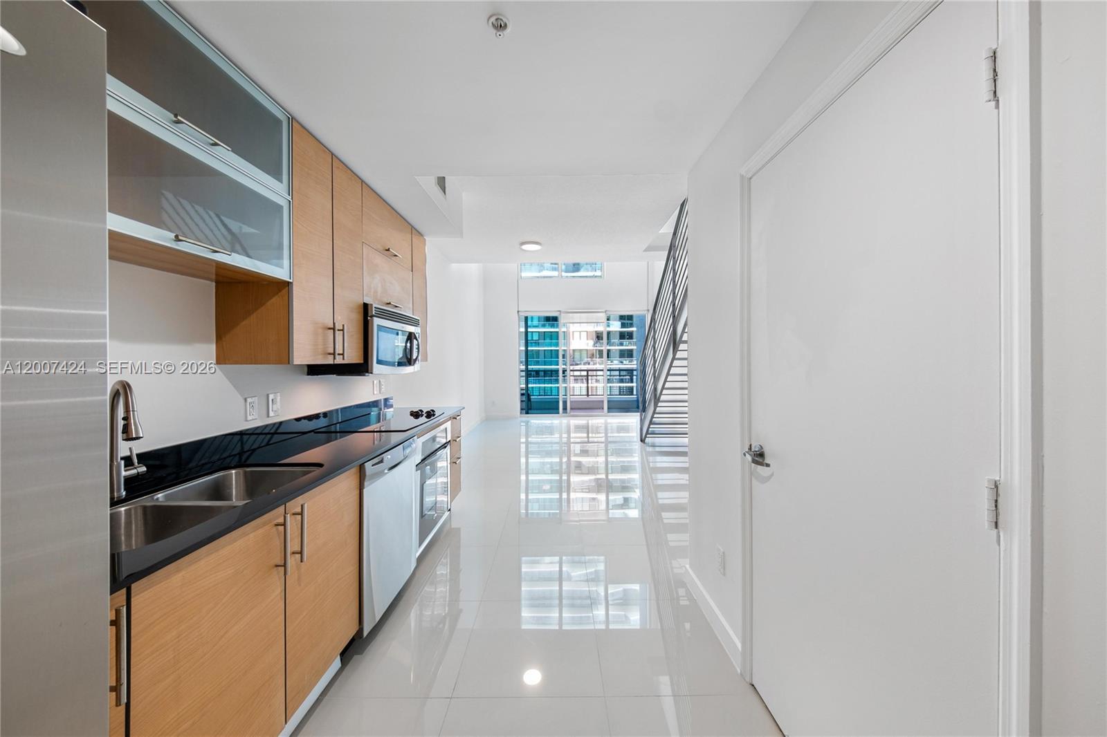 60 Southwest 13th Street, Unit 2420 Miami, FL 33130 - Photo 11 of 30 a kitchen with stainless steel appliances a sink stove and cabinets