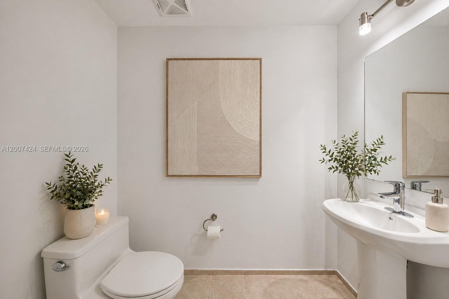 60 Southwest 13th Street, Unit 2420 Miami, FL 33130 - Photo 26 of 30 a bathroom with a toilet sink and mirror