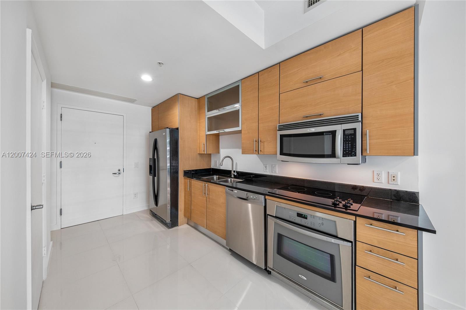 60 Southwest 13th Street, Unit 2420 Miami, FL 33130 - Photo 4 of 30 a kitchen with stainless steel appliances a stove microwave and sink