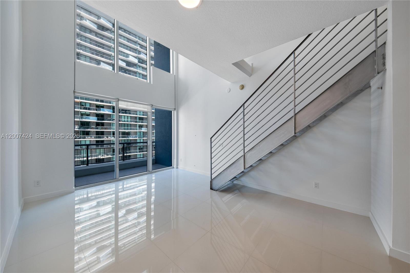 60 Southwest 13th Street, Unit 2420 Miami, FL 33130 - Photo 7 of 30 a view of a livingroom with a staircase