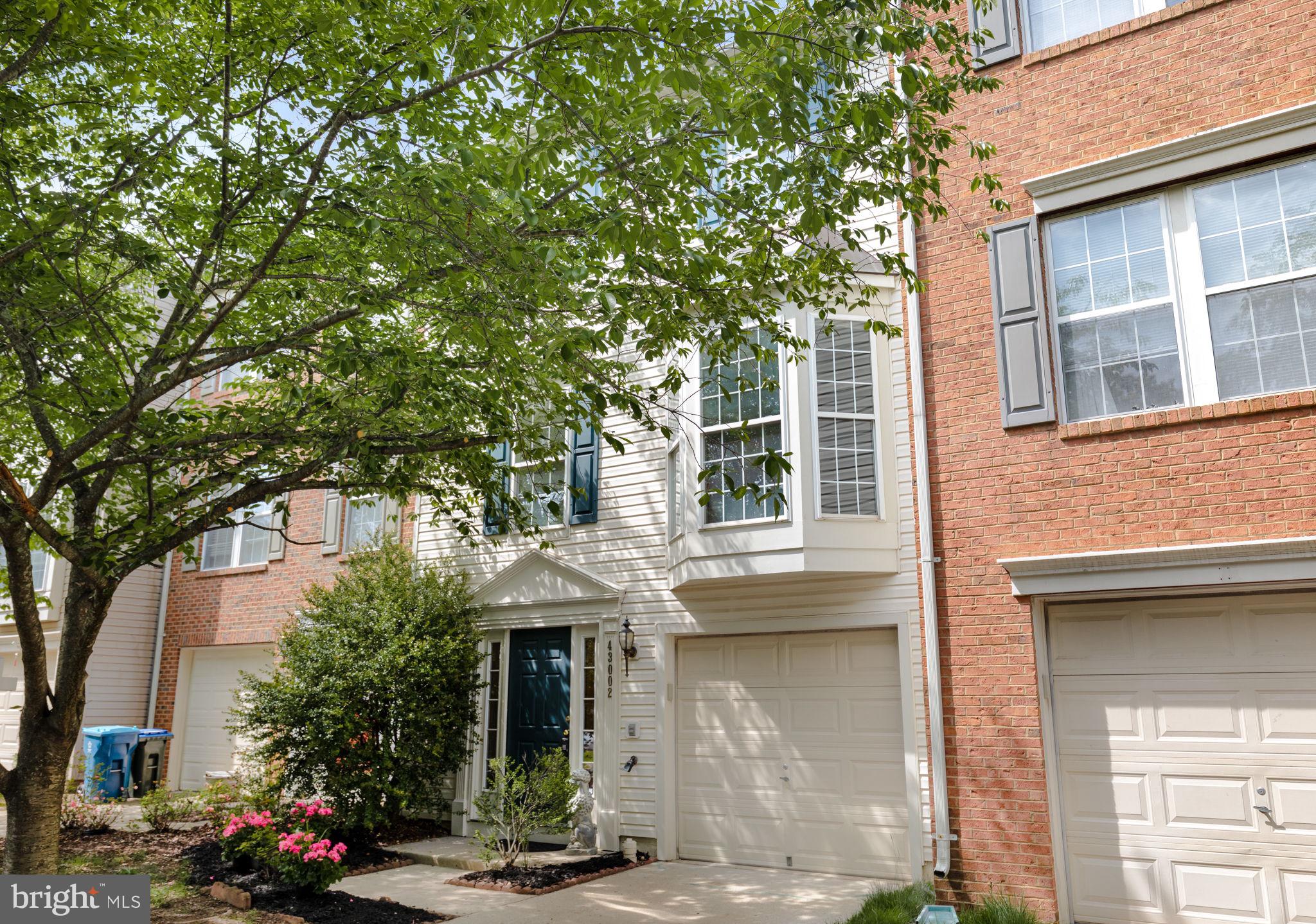 a front view of a house with trees