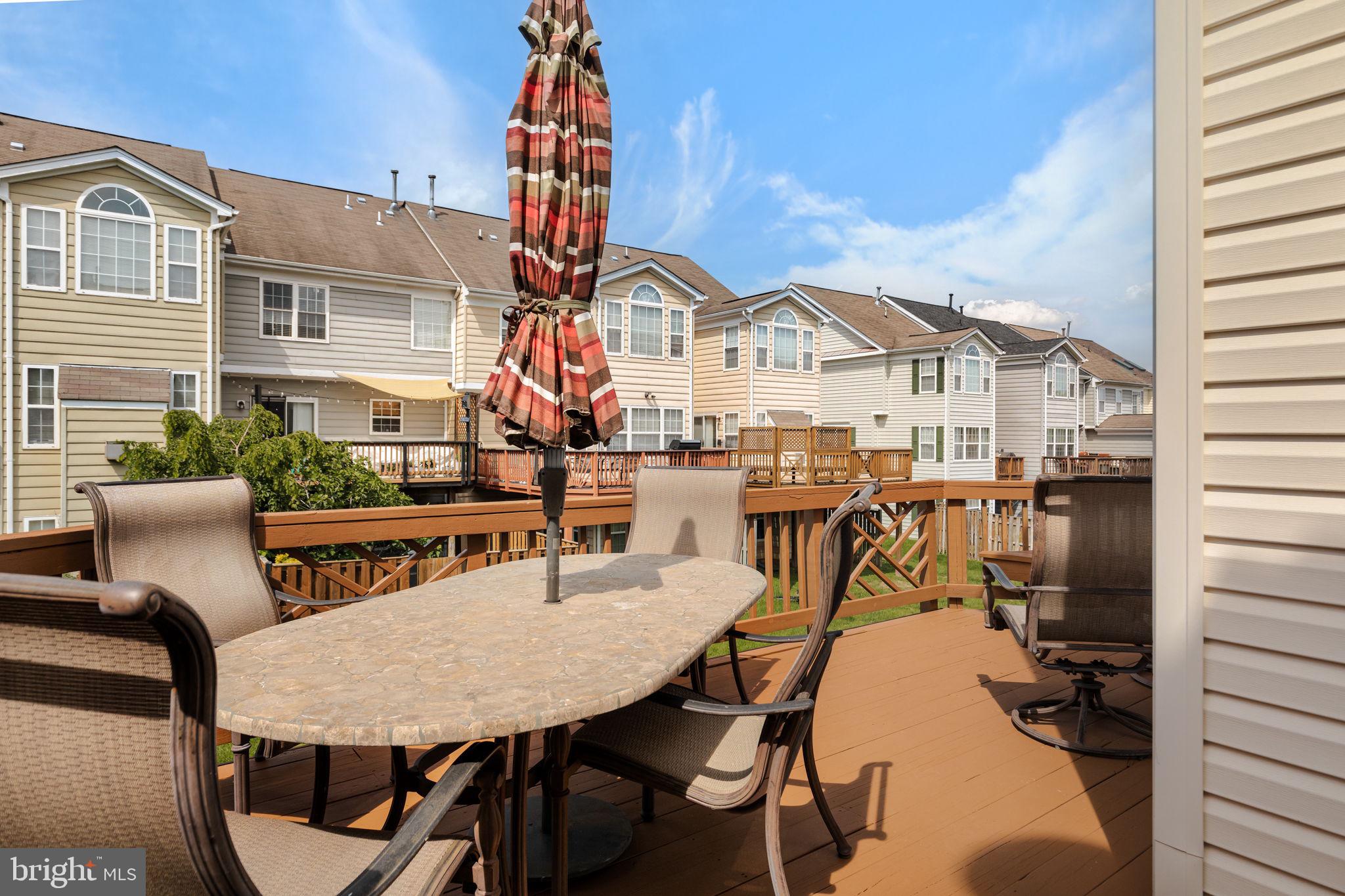 43002 Center Street Chantilly, VA 20152 - Photo 11 of 35 a view of a patio with table and chairs with wooden floor and fence