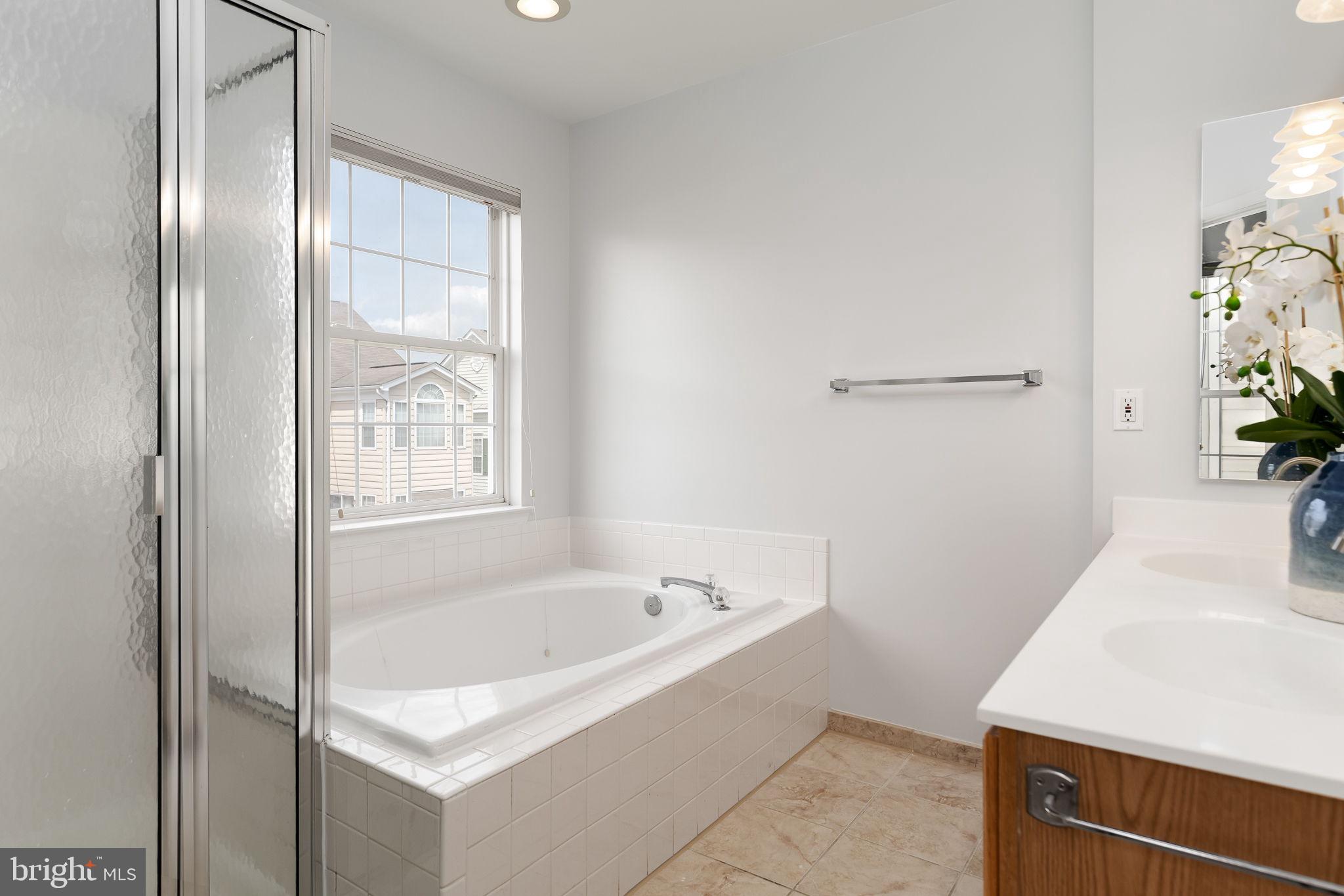 43002 Center Street Chantilly, VA 20152 - Photo 16 of 35 a bathroom with a tub and shower
