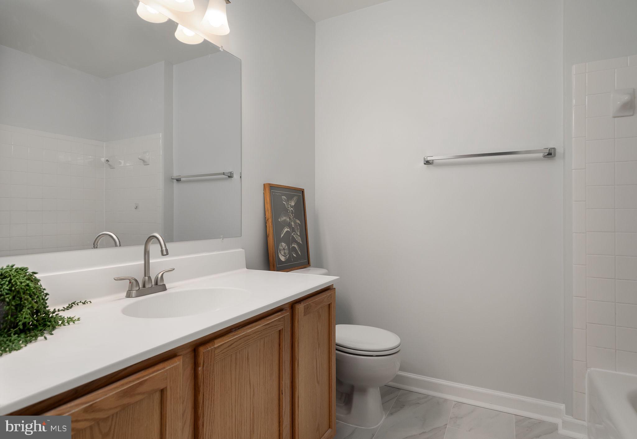 43002 Center Street Chantilly, VA 20152 - Photo 19 of 35 a bathroom with a sink vanity and a toilet