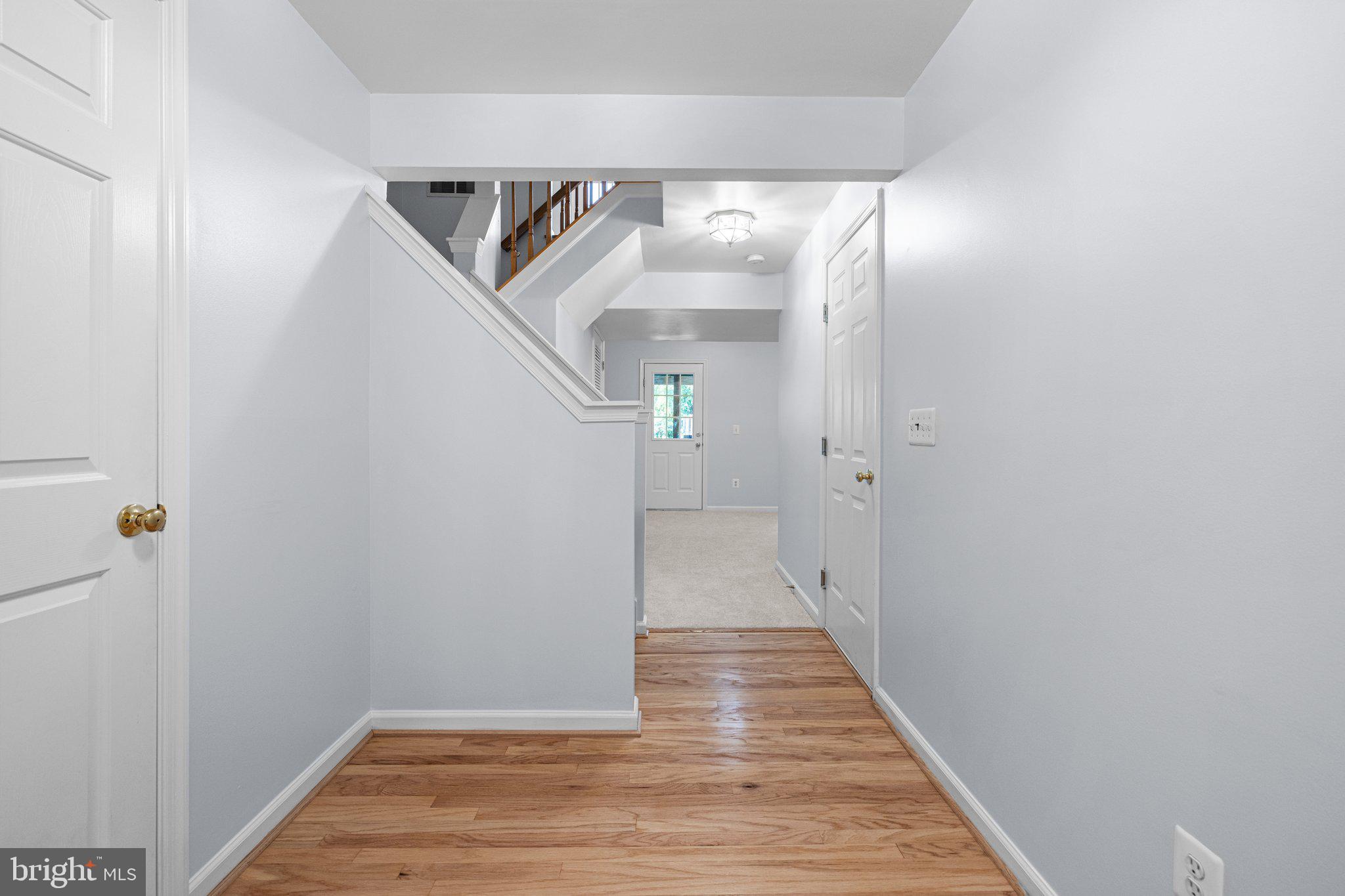 43002 Center Street Chantilly, VA 20152 - Photo 3 of 35 a view of a hallway with wooden floor and entryway