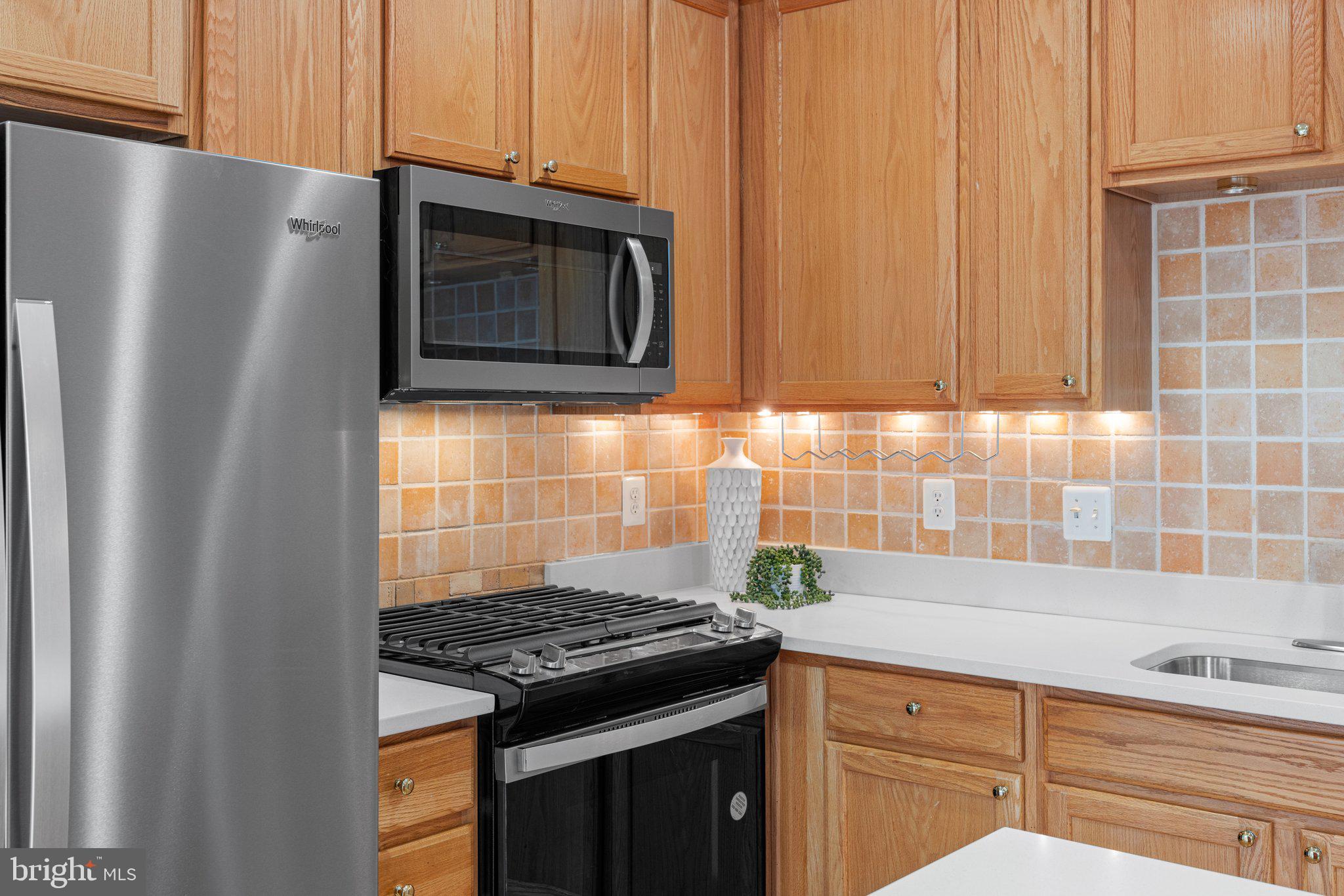 43002 Center Street Chantilly, VA 20152 - Photo 8 of 35 a kitchen with granite countertop a stove and a microwave
