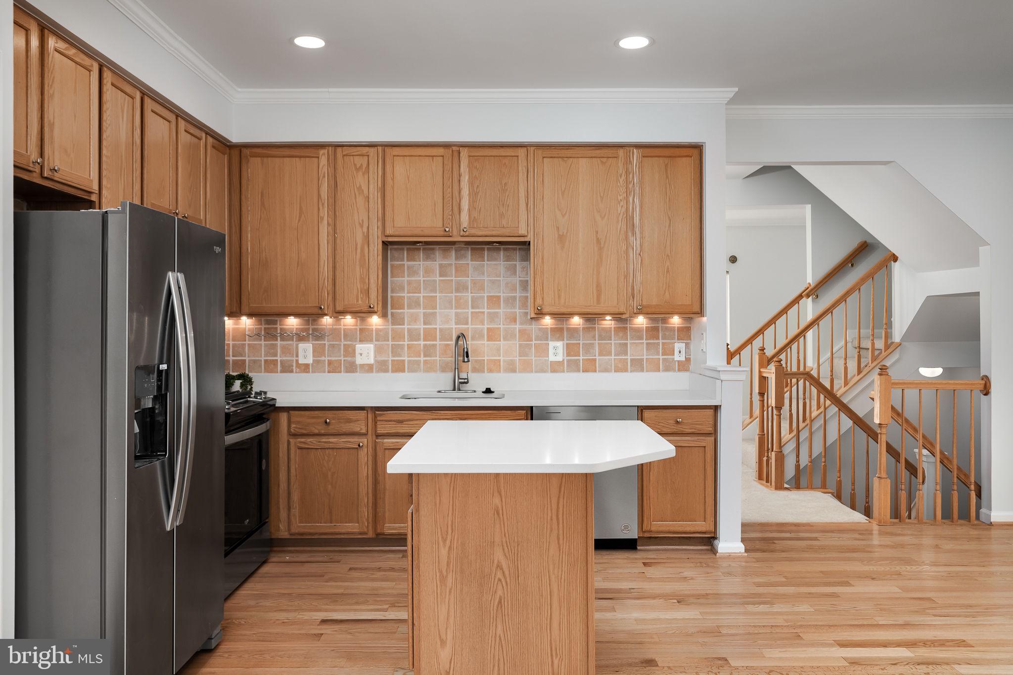43002 Center Street Chantilly, VA 20152 - Photo 9 of 35 a kitchen with stainless steel appliances a sink and a refrigerator