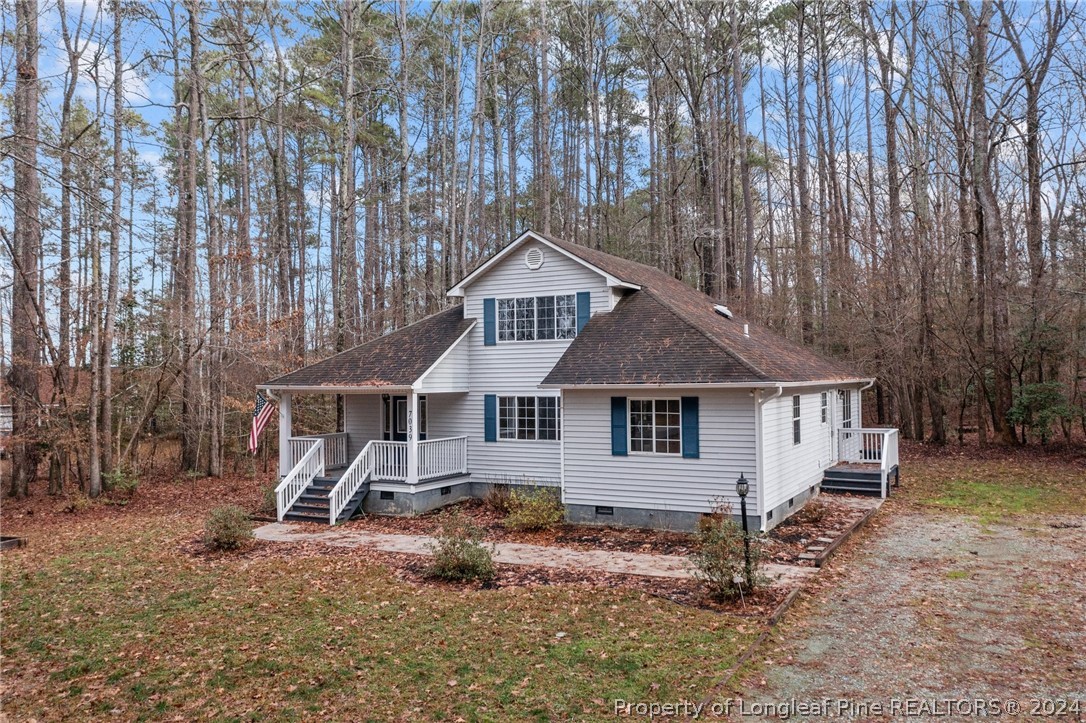 an aerial view of a house with a yard and large trees
