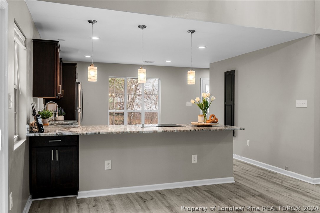 7039 Pine Road Sanford, NC 27332 - Photo 11 of 35 a living room with granite countertop kitchen island with furniture and wooden floor