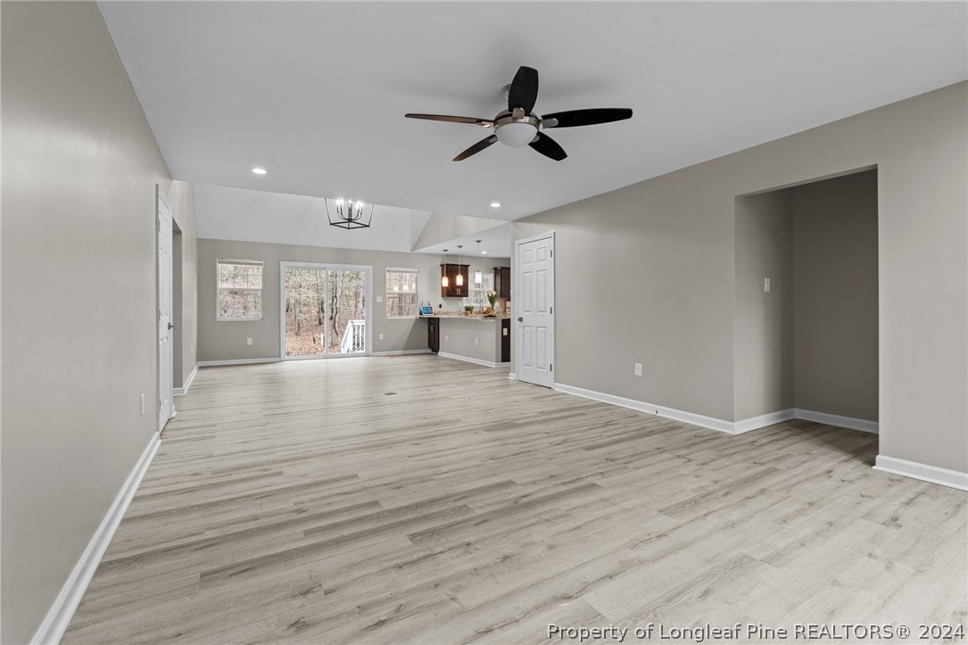 7039 Pine Road Sanford, NC 27332 - Photo 16 of 35 a view of empty room with wooden floor and window