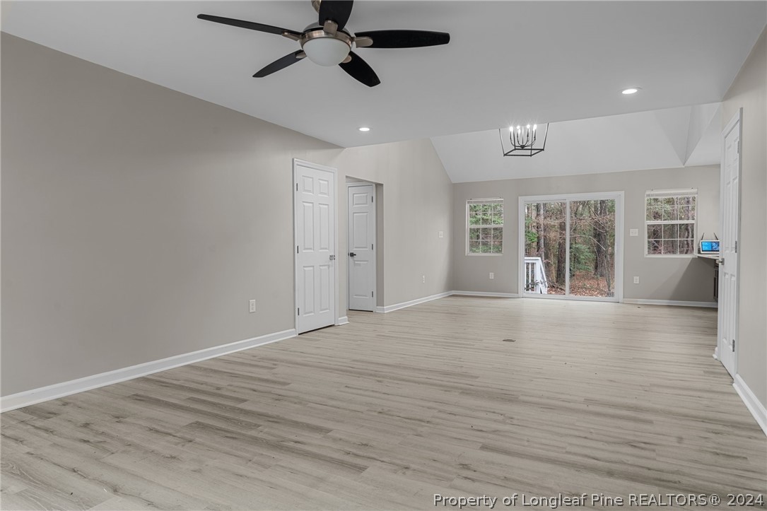 7039 Pine Road Sanford, NC 27332 - Photo 17 of 35 a view of an empty room with wooden floor and a window