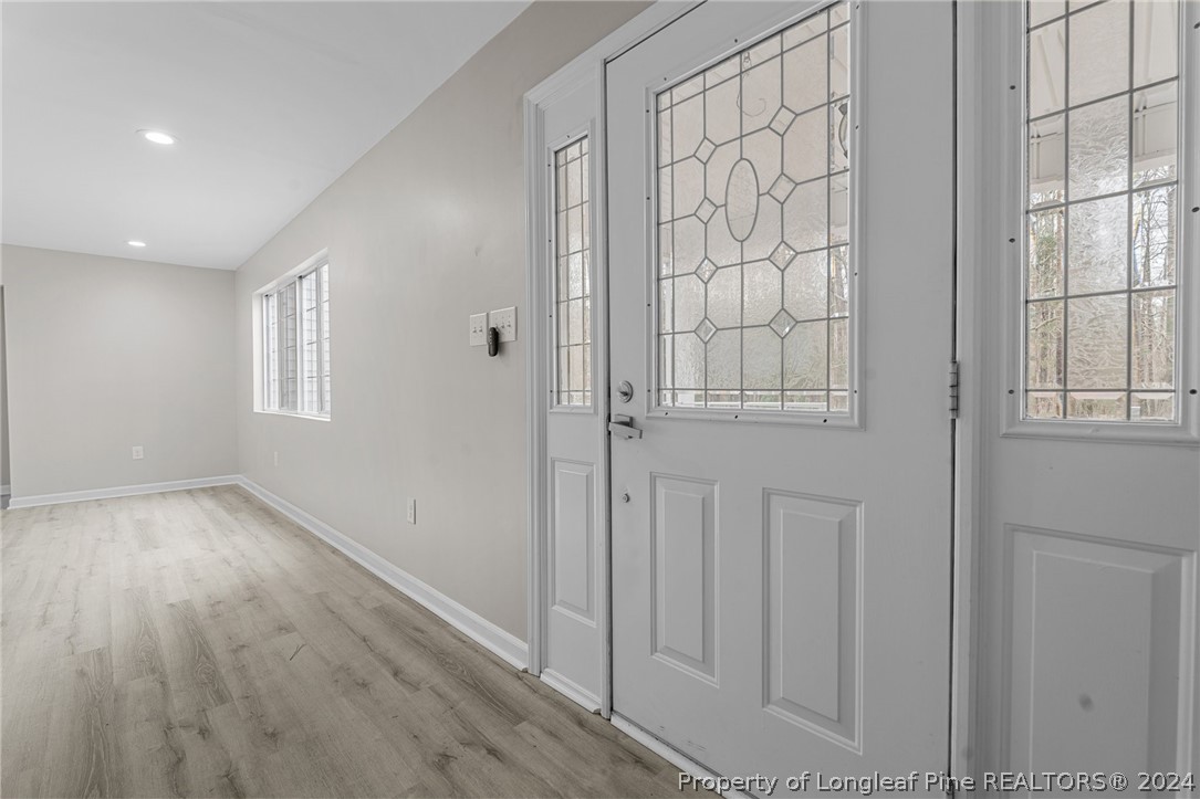 7039 Pine Road Sanford, NC 27332 - Photo 18 of 35 an empty room with wooden floor and windows