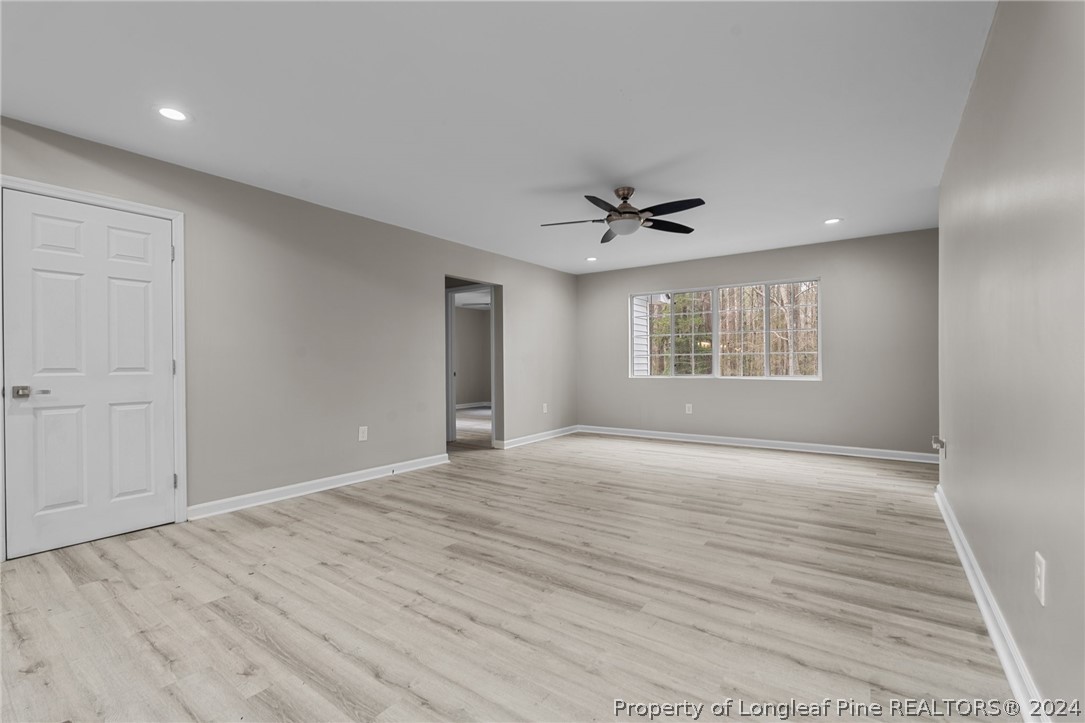 7039 Pine Road Sanford, NC 27332 - Photo 20 of 35 a view of an empty room with a window and wooden floor