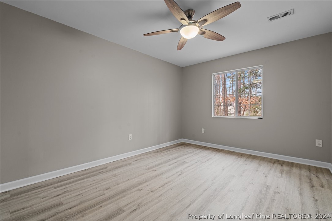 7039 Pine Road Sanford, NC 27332 - Photo 21 of 35 wooden floor in an empty room with a window