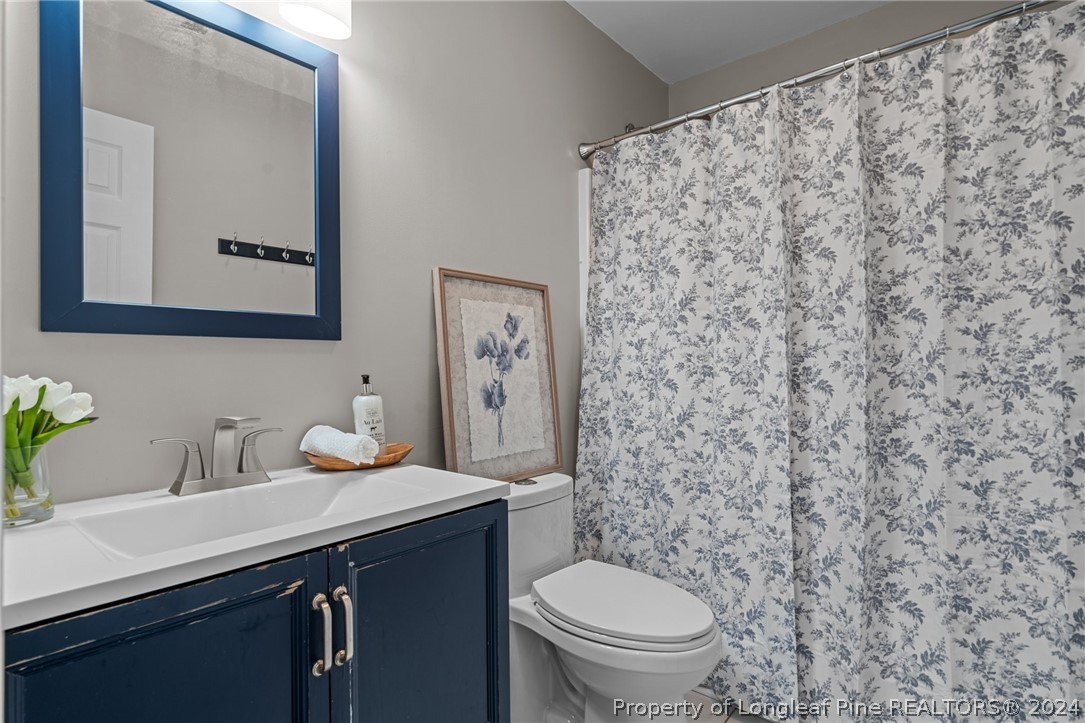 7039 Pine Road Sanford, NC 27332 - Photo 23 of 35 a bathroom with a sink and a toilet