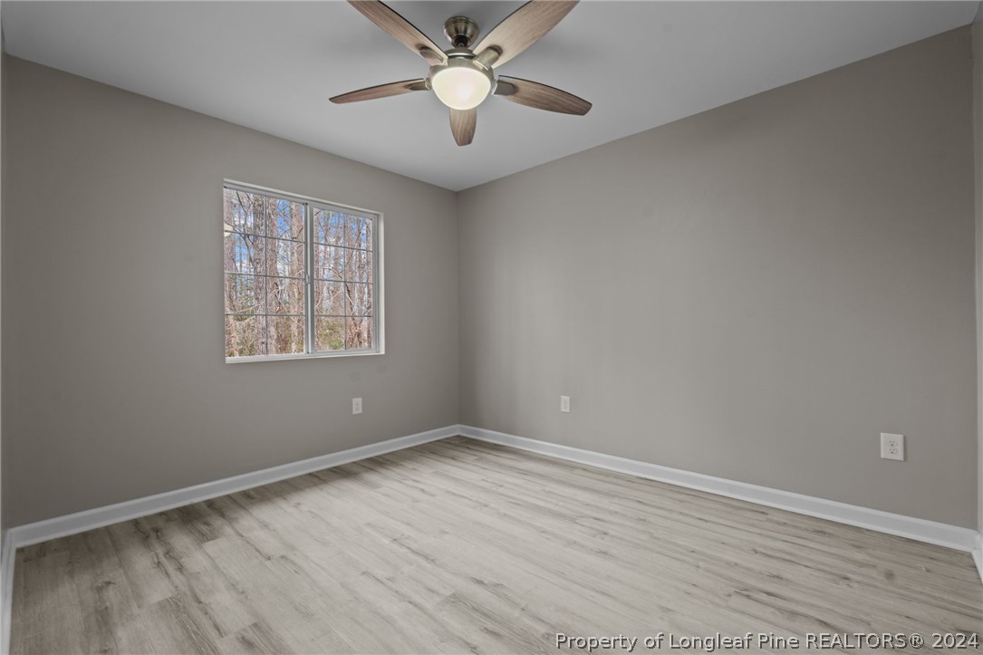 7039 Pine Road Sanford, NC 27332 - Photo 24 of 35 a view of an empty room with a window and a fan