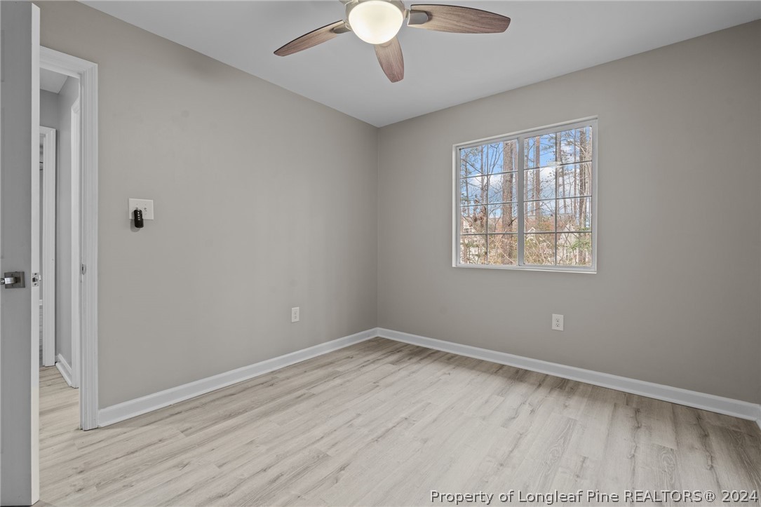 7039 Pine Road Sanford, NC 27332 - Photo 25 of 35 a view of an empty room with wooden floor and a window