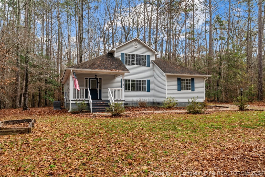 7039 Pine Road Sanford, NC 27332 - Photo 3 of 35 a front view of a house with a yard and garage