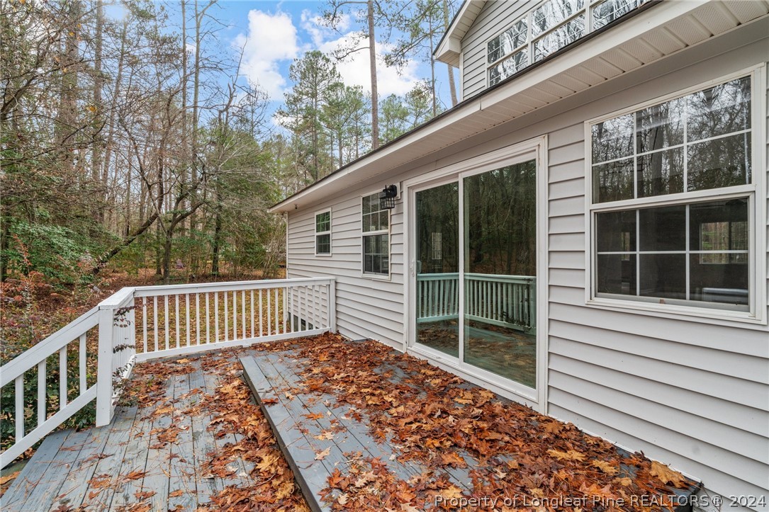 7039 Pine Road Sanford, NC 27332 - Photo 33 of 35 a porch with a bench next to a yard