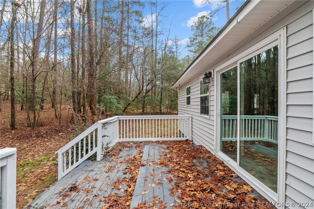 7039 Pine Road Sanford, NC 27332 - Photo 34 of 35 a view of a wooden house with a large window