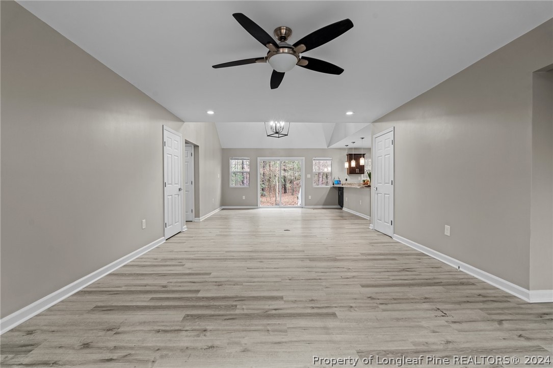 7039 Pine Road Sanford, NC 27332 - Photo 6 of 35 a view of an empty room with wooden floor and a ceiling fan