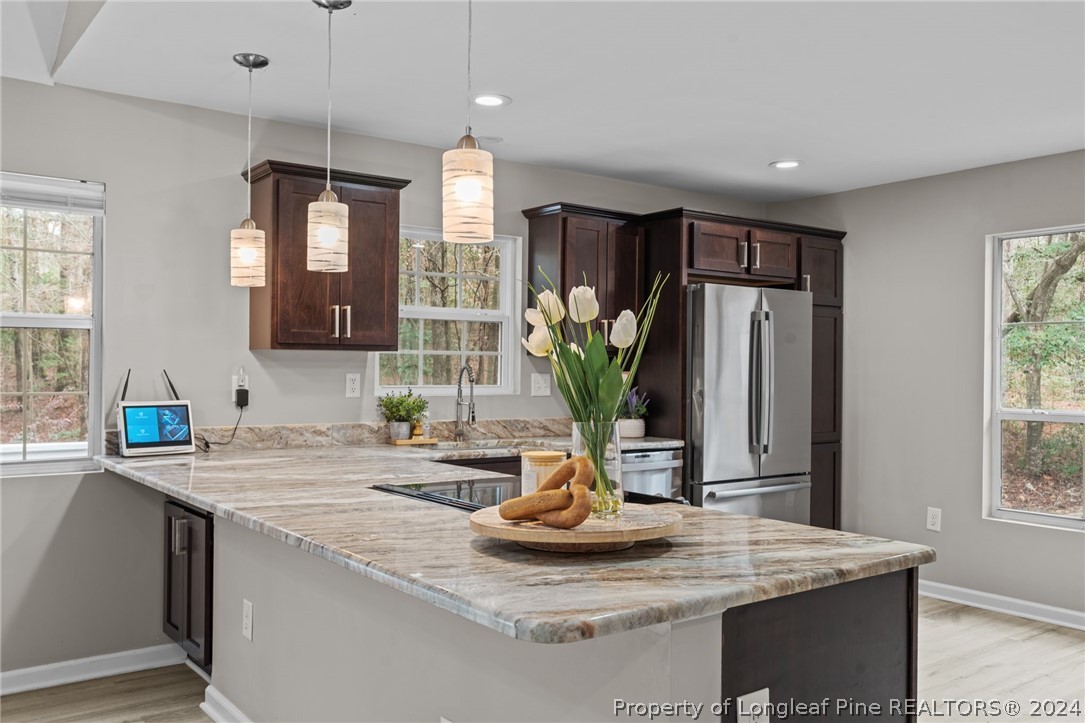 7039 Pine Road Sanford, NC 27332 - Photo 9 of 35 a kitchen with kitchen island a sink and living room