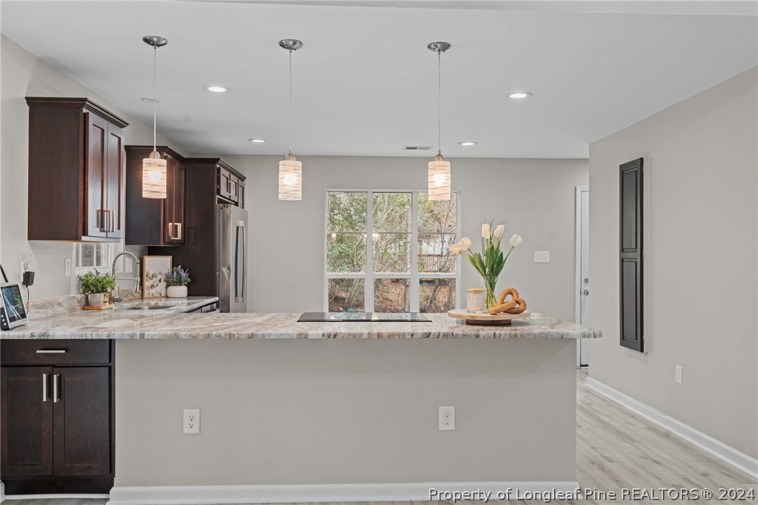 7039 Pine Road Sanford, NC 27332 - Photo 10 of 35 a room with stainless steel appliances kitchen island granite countertop a sink and cabinets