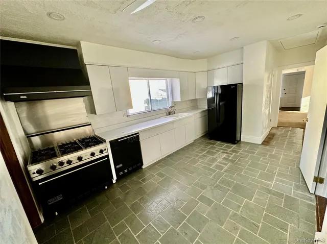 a kitchen with a refrigerator and a stove