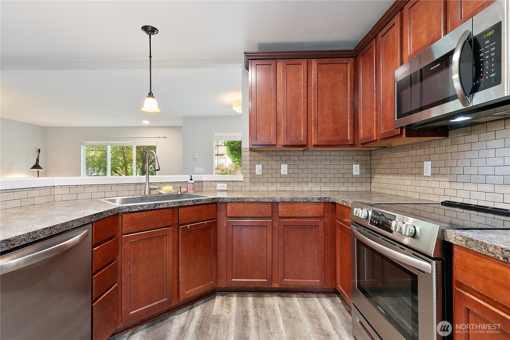 6600 Indiana Street Southeast Lacey, WA 98513 - Photo 9 of 21 a kitchen with stainless steel appliances granite countertop a sink a stove and cabinets