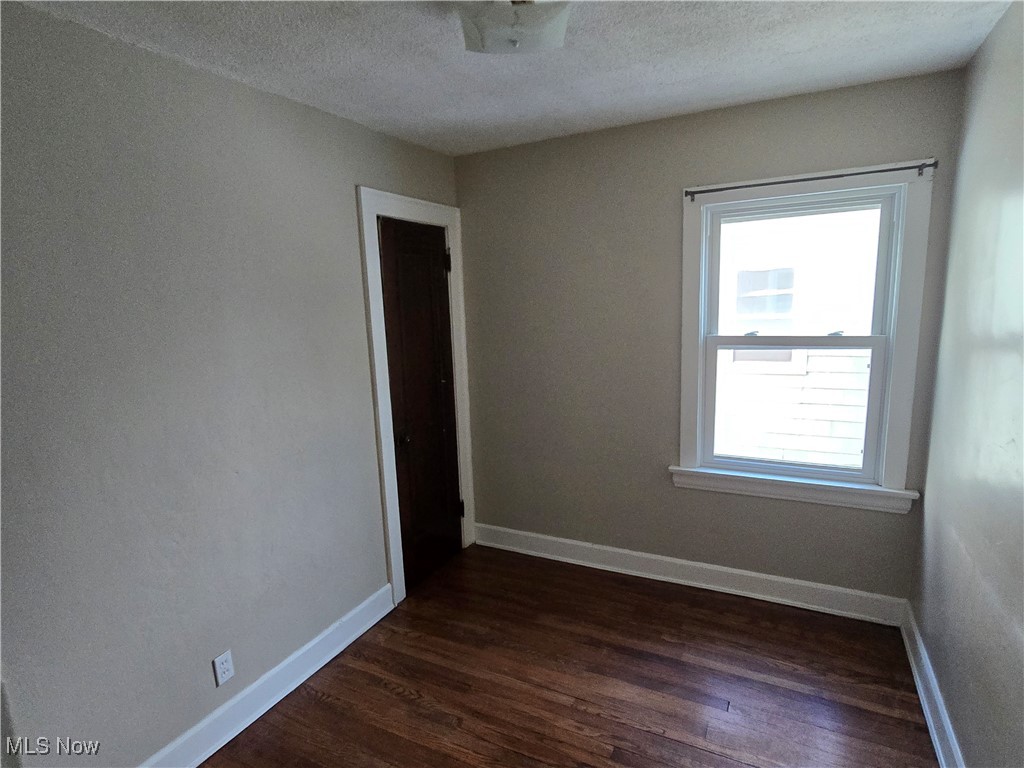 2048 Rossmoor Road Cleveland Heights, OH 44118 - Photo 24 of 29 Spare room with dark wood-type flooring and a textured ceiling