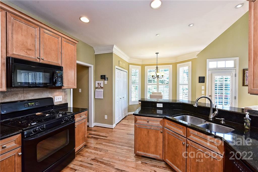 7115 Ramsgate Road Charlotte, NC 28270 - Photo 16 of 39 a kitchen with granite countertop a stove and a sink