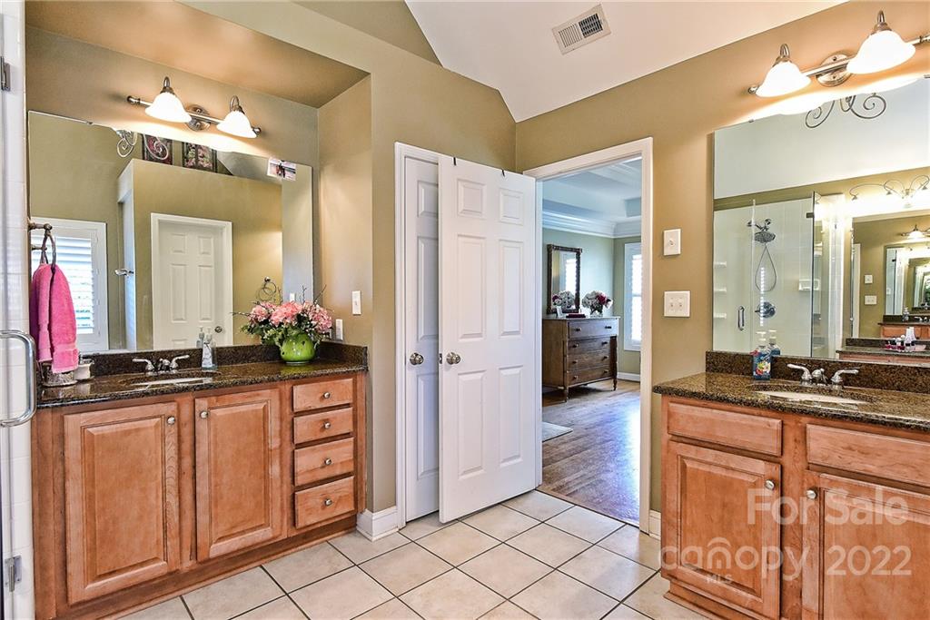 7115 Ramsgate Road Charlotte, NC 28270 - Photo 25 of 39 a spacious bathroom with a sink and a mirror
