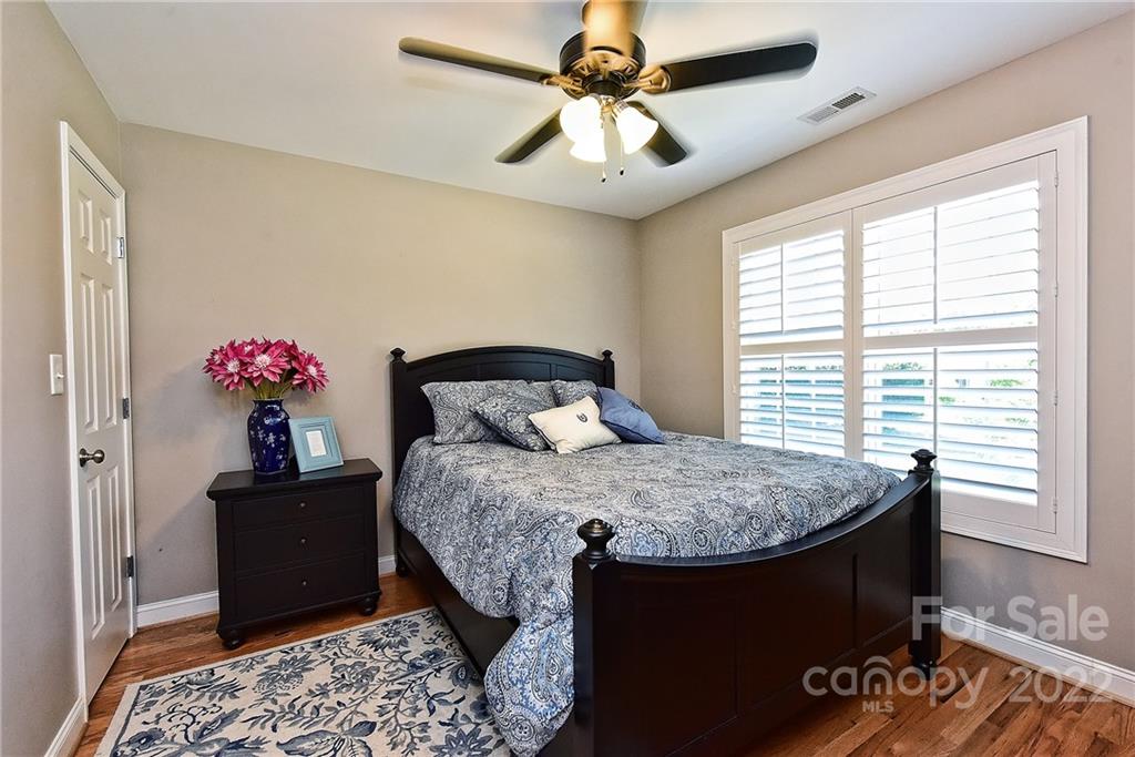 7115 Ramsgate Road Charlotte, NC 28270 - Photo 27 of 39 a bedroom with a bed and a chandelier