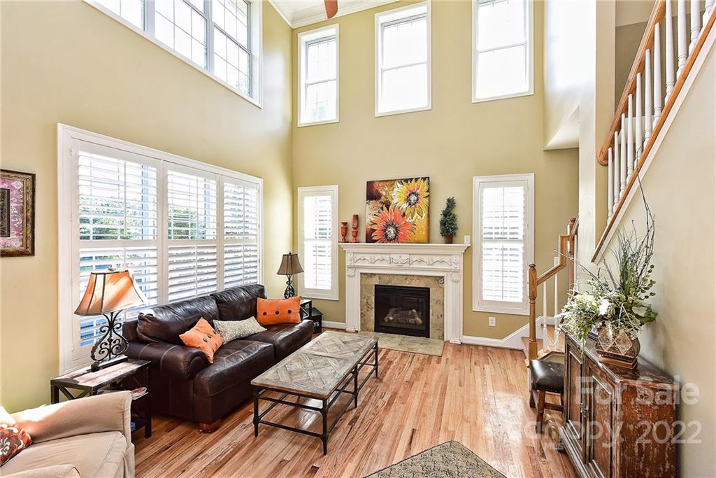 7115 Ramsgate Road Charlotte, NC 28270 - Photo 3 of 39 a living room with furniture a fireplace and a floor to ceiling window