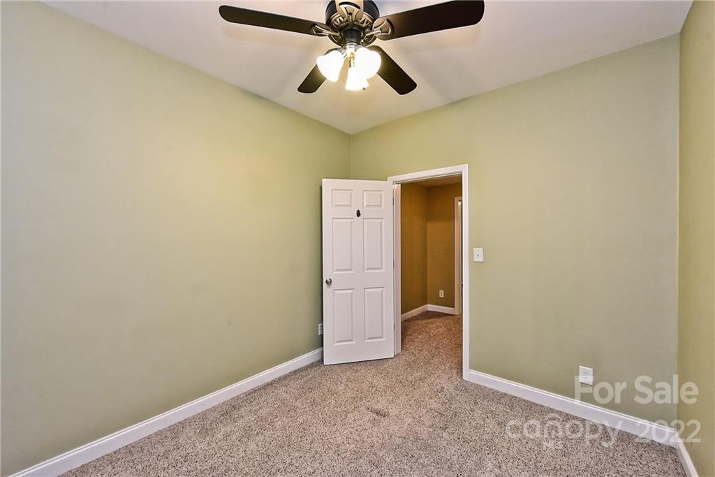 7115 Ramsgate Road Charlotte, NC 28270 - Photo 33 of 39 an empty room and chandelier fan
