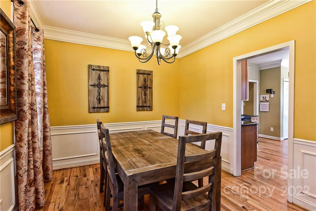 7115 Ramsgate Road Charlotte, NC 28270 - Photo 9 of 39 a view of a dining room with furniture and a chandelier
