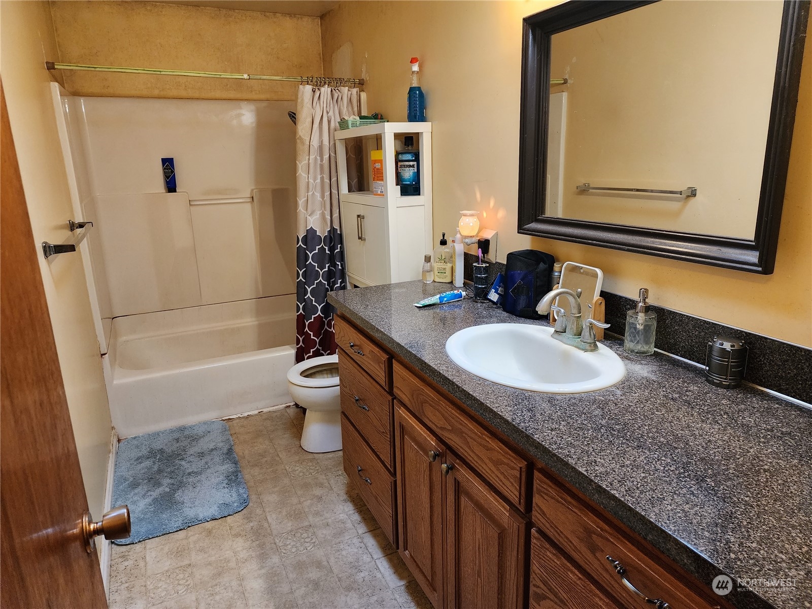 447 Independence Road Rochester, WA 98579 - Photo 12 of 35 a bathroom with a granite countertop sink and mirror with bathtub