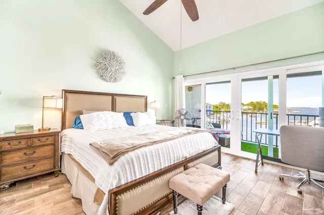 a bedroom with a bed window and a flat screen tv
