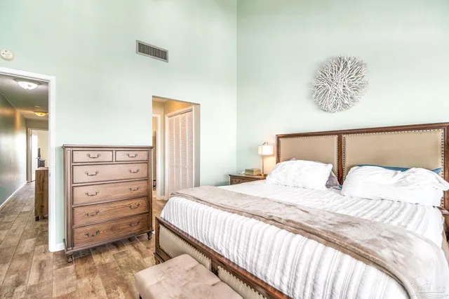 a bedroom with a bed and a night stand